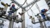 Electricians work on power lines on the outskirts of the Moldovan city of Balti on November 2.