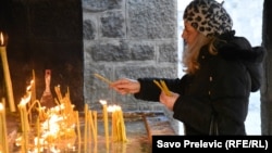 A member of the Serbian Orthodox Church attends a service during Orthodox Christmas Eve celebrations in Cetinje, Montenegro, January 6. The Montenegrin Orthodox Church also held an event in the town on the same day just a few hundred meters away. 