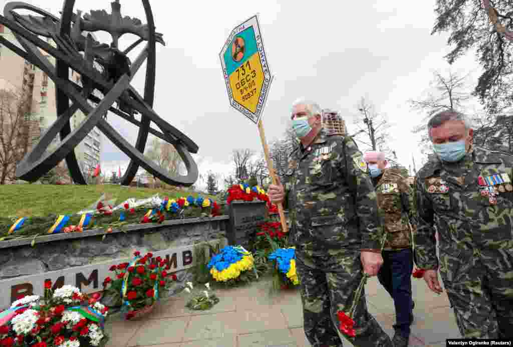 People in the Ukrainian capital, Kyiv, attend an April 26 memorial to firefighters and workers who died in the 1986 catastrophe.