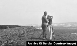 Photographer Samson Chernov standing in front of a Serbian position during the First Balkan War.