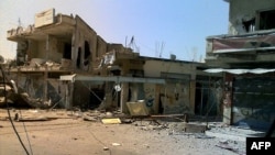 Some gutted buildings remain after heavy shelling by Syrian government forces in the central city of Qusair earlier this year. 