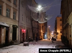 A red light and statue of Masoch (left) marks the entrance to the Masoch Cafe and hotel in central Lviv.