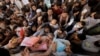 Afghans gather outside the passport office in Kabul in October 2021, two months after the Taliban seized power in Afghanistan. Hundreds of thousands of Afghans have fled the country since then.