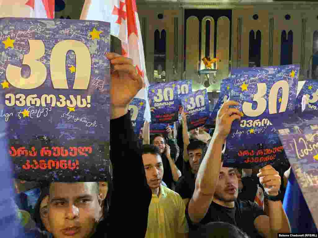 Protesters hold up signs that say, &quot;Yes to Europe&quot; and &quot;No to Russian law&quot; on April 16. The controversial law would require media and nongovernmental organizations (NGO&#39;s) that receive more than 20 percent of their funding from abroad to register and report their activities to the authorities. &nbsp;