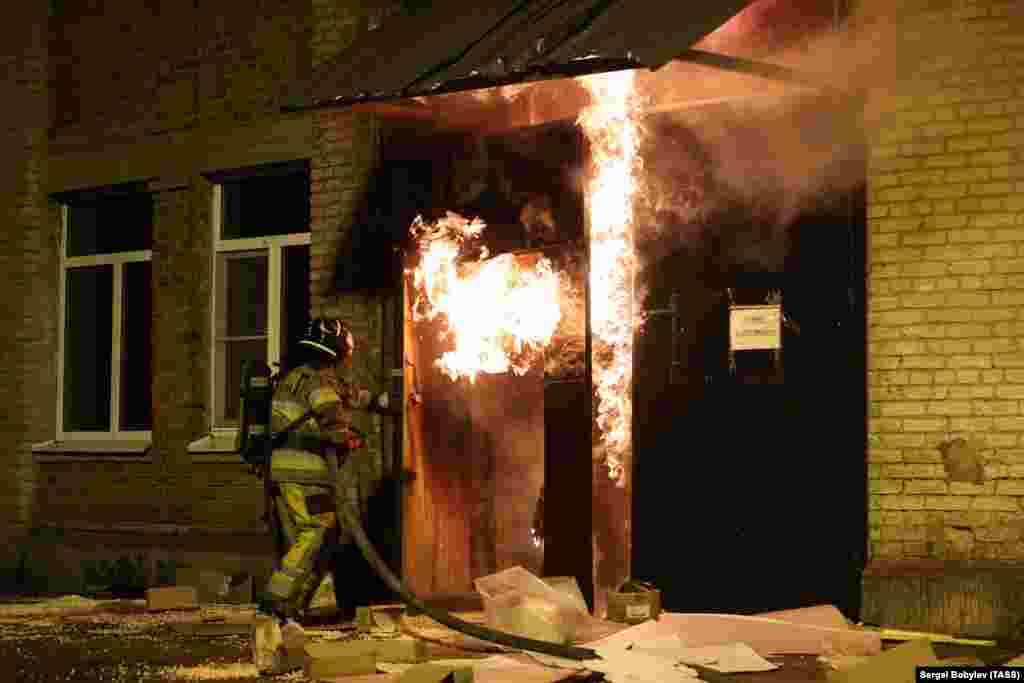 A firefighter at the entrance to a factory in Khimki, near Moscow, that erupted in flames on July 3.