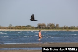 A woman emerges from Lake Balkhash on August 21.