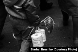 A child carries rolls of scarce toilet paper during a march in honor of the October Revolution on November 7, 1988.