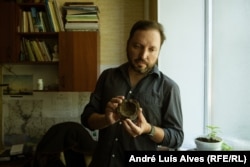 Anatoliy Volkov shows a cannonball from the Cossack period.