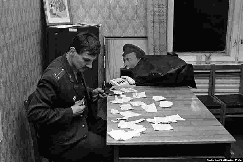 An inspector collects a torn report, Minsk, 1991.