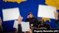 Ukrainian President Volodymyr Zelenskiy listens to a journalist's question during his annual press conference in Kyiv on December 19, 2023.