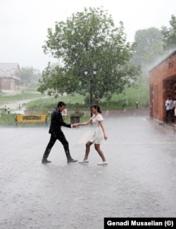 High school students dance outside the Stepanakert Cathedral during their graduation ceremony. The city is known as Xankendi in Azeri.