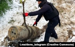 Workers recover a fragment of a Kinzhal hypersonic missile that struck Kyiv in January.