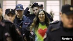 Alexandra (Sasha) Skochilenko, a 33-year-old artist and musician, is escorted inside a court building in St. Petersburg, Russia, on November 16.