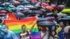 People brave the rain to attend the Pride Parade in Sofia on June 17.