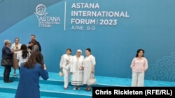 Visitors pose for photographs ahead of this year's Astana International Forum in Kazakhstan. 