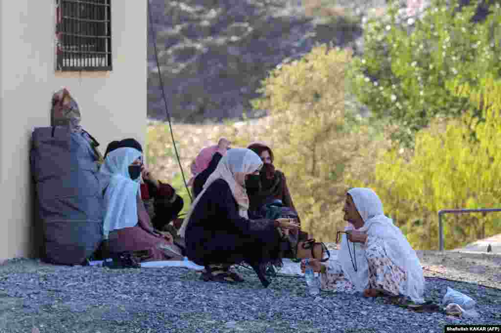 Afghan women sit along a road on September 11 as they wait for the reopening of the border crossing. The Tehrik-e Taliban Pakistan (TTP) extremist group, which is believed to be based in Afghanistan, said in a September 6&nbsp;statement&nbsp;that a large number of its fighters had entered Chitral.&nbsp;