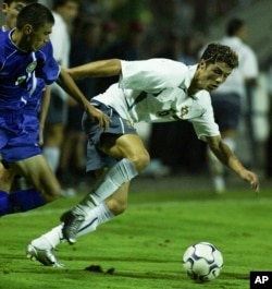 Portugal's Cristiano Ronaldo drives the ball past Kazakhstan's Renat Abdalin during a friendly soccer match in 2003 in Chaves, Portugal, Ronaldo's first for his country.