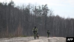 Belarusian border guards patrol along the frontier near the Divin border crossing point between Belarus and Ukraine in the Brest region on February 15, 2023. 