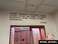 Inside the military museum, Viktor Pristupa is seen with a quote from Vladimir Putin: "The army is respected and recognized only when it knows to defends the interests of its citizens, and knows how to win."