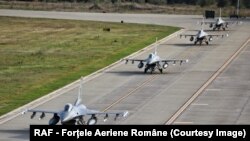 American F-16s taxi on the runway at the newly opened European F-16 Training Center in Borcea, Romania.