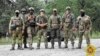 In a photo released by Belarus's Defense Ministry on July 20, Belarusian special forces and mercenaries pose during maneuvers near the border city of Brest. 