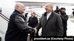 Alyaksandr Lukashenka (left) is greeted by Ilham Aliyev at the Fuzuli airport on May 17.