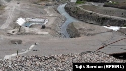 The beginning of the Romit River where a basin was created for the Pokrud gold mine that sends discharge from the mine into the river.