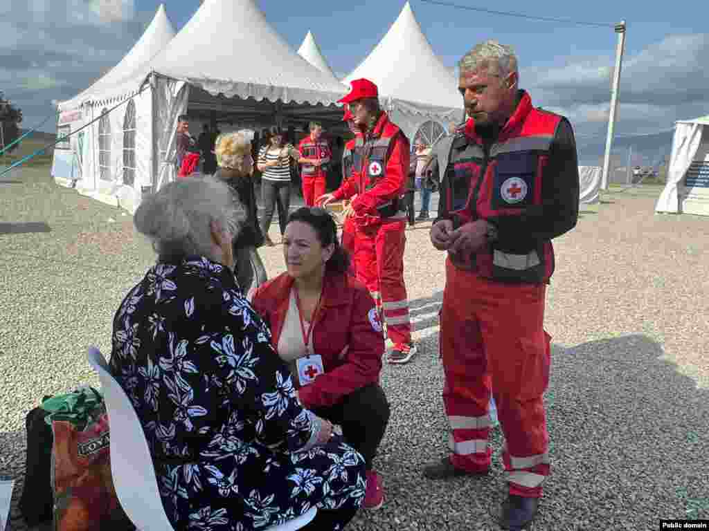 Red Cross workers speak with a refugee in Kornidzor on September 24.&nbsp; Some residents of Nagorno-Karabakh are moving from isolated villages toward Stepenakert amid increasing uncertainty. &quot;We are still moving to Stepanakert,&quot; one ethnic Armenian villager told RFE/RL. &quot;Let&#39;s see what is decided.&nbsp;It&#39;s still uncertain,&quot; they said.&nbsp;