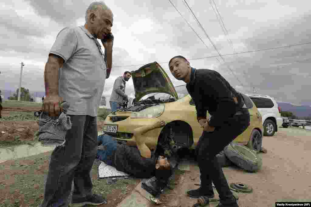 Armenian refugees repair a car on the road from Nagorno-Karabakh to Armenia. The war in 2020 ended with a Russian-brokered cease-fire and the deployment of Russian peacekeepers. Those peacekeepers did little, however, to prevent the advances by Azerbaijani forces as they launched what they called an &quot;anti-terrorist operation&quot; in Nagorno-Karabakh. &nbsp;