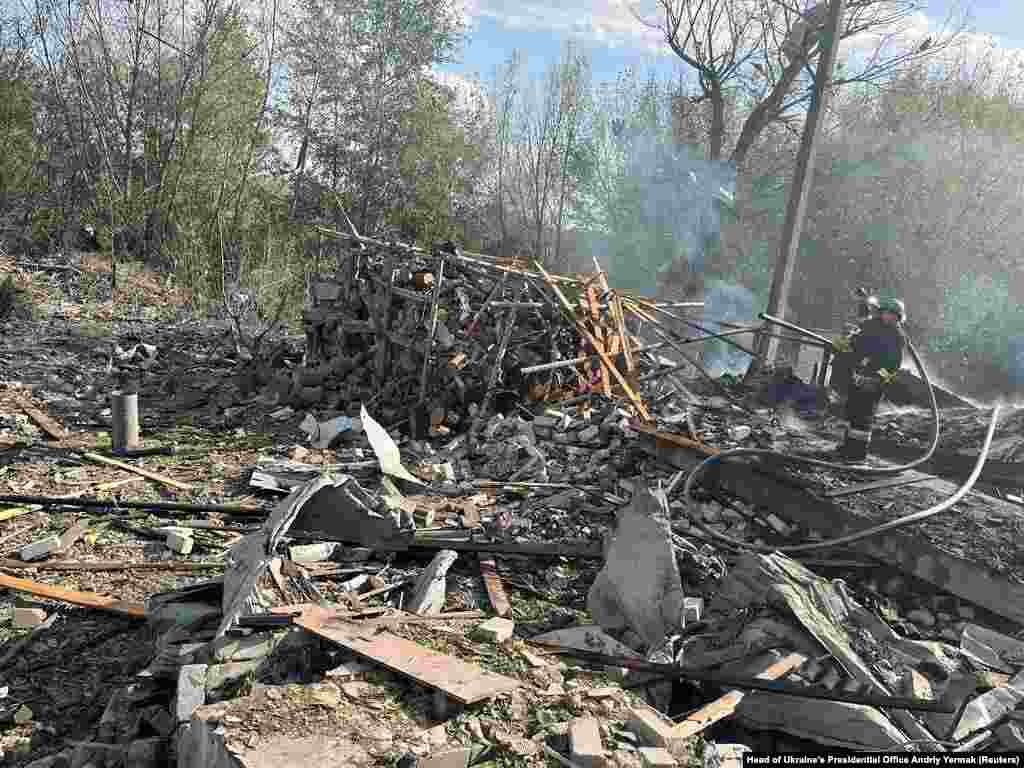 Firefighters work at the site of the missile strike.&nbsp; Kharkiv&nbsp;regional Governor Oleh Synyehubov said that a cafe and a shop had been hit at around lunchtime in the village of Hroza in the Kupyansk district of Kharkiv&nbsp;and that many civilians had been there at the time.