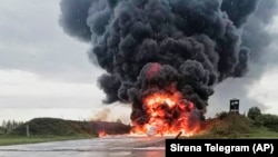 A Russian warplane burns at the Soltsy air base on August 19. 