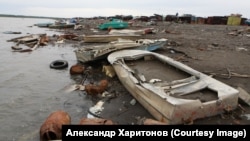 The litter-strewn banks of the Norilsk River.