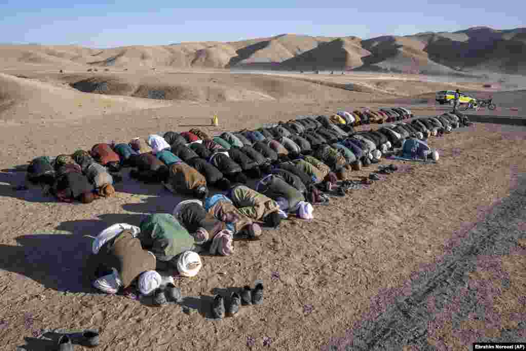 Afghans pray for relatives who were killed in an earthquake at a burial site in Zindah Jan. The rugged area is difficult to reach, and local officials have given conflicting&nbsp;casualty tolls&nbsp;from the series of quakes in the area. On October 8, a member of the Taliban-led government said the updated death toll had surpassed 2,000.