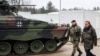 German Defense Minister Boris Pistorius (right) walks past a Marder infantry fighting vehicle type at a training center in Munster, northern Germany, on February 20. 