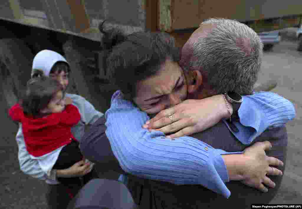 Armenians embrace after arriving in Kornidzor, Armenia. &nbsp;