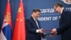 Chinese leader Xi Jinping (left) and Serbian President Aleksandar Vucic exchange agreements during a signing ceremony on May 8 in Belgrade.