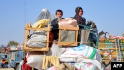 Afghan refugees arrive from Pakistan at the Afghanistan-Pakistan border in the Spin Boldak district of Kandahar Province on December 3.