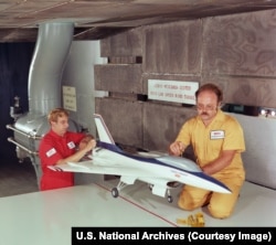 A model of an F-16 is prepared for wind tunnel testing at a NASA facility in Ohio in August 1983.