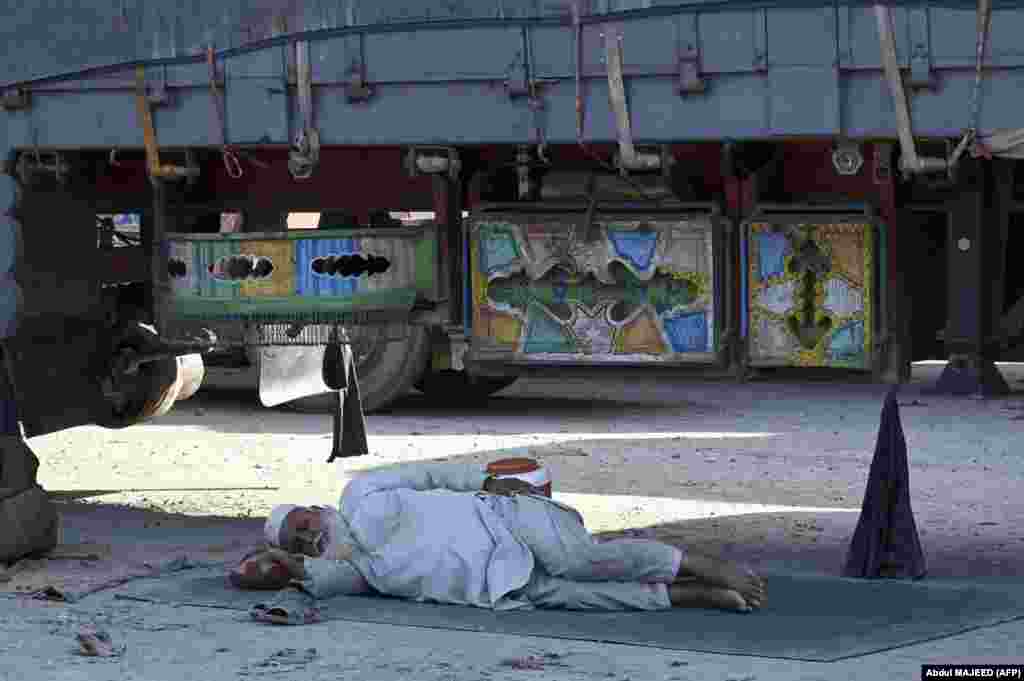 A man takes a nap under a truck near the Pakistani-Afghan border at Torkham on September 11.&nbsp; Hundreds of trucks and travelers were left stranded a week into the closure of the border, after a gunfight erupted across the frontier&nbsp;that left a Taliban guard and an Afghan civilian dead on September 6.