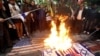 Iranians burn Israeli and U.S. flags during a protest at Palestine Square in Tehran on April 1.