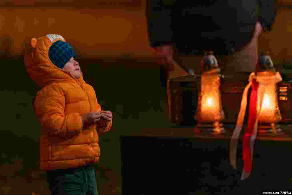 A child looks on during the memorial in the Lithuanian capital. Vilnius has become home to thousands of Belarusian exiles who left their country after the violent crackdown on demonstrations that erupted after Lukashenka declared victory in a 2020 presidential election widely seen as rigged.