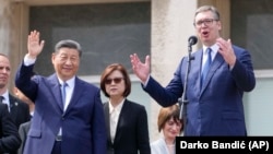 Xi Jinping (left) looks on as Serbian President Aleksandr Vucic speaks at the Palace of Serbia on May 8 while the Chinese leader was on a two-day visit to Belgrade.