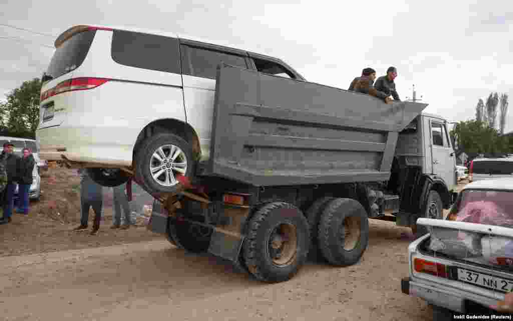 A truck carrying a minivan and refugees arrives in Armenia. Prior to its offensive, Azerbaijan had maintained a monthslong blockade of Nagorno-Karabakh, claiming it had concerns about illicit weapon shipments, which cut the 120,000 residents off from essential supplies. &nbsp;