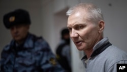 Aleksei Moskalyov is escorted from a courtroom in Yefremov in Russia's Tula region, some 300 kilometers south of Moscow, on March 27.