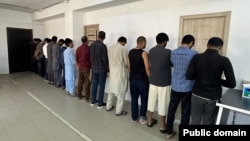 Pakistanis arrested for illegally working in Kyrgyzstan are lined up by law enforcement in Bishkek on May 15.