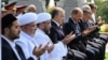 Mufti Nuriddin Kholiqnazarov (from 3rd left to right), President Shavkat Mirziyoev, and Prime Minister Abdulla Aripov pray during a public appearance in Tashkent on August 31.