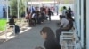 A long line of Turkmen wait outside the offices of the country's Migration Service in the eastern city of Turkmenabat in Lebap Province. (file photo)