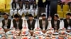 Afghan grooms attend a mass wedding ceremony at a hall in Kandahar, Afghanistan, on February 28.