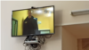 Aleksei Navalny appears on a video feed from prison during the trial of a former associate in April.