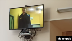 Aleksei Navalny appears on a video feed from prison during the trial of a former associate in April.